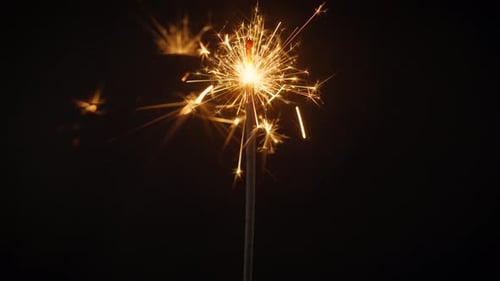 Beautiful Sparks From Cold Stick Fires on a Black Background