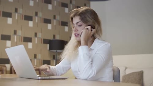 Young Woman Working From Home on Laptop, On Phone