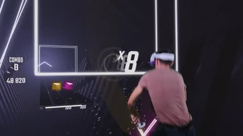 Man Playing Virtual Reality Rhythm Game with Controllers