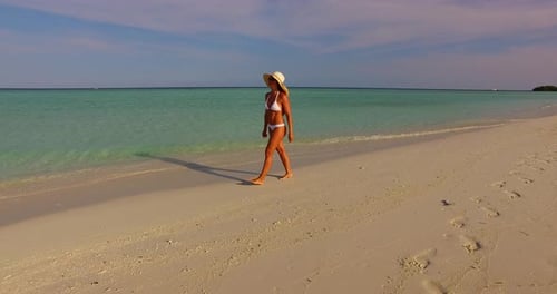 Sexy fun woman on photoshoot having fun on the beach on paradise white sand and blue background 4K