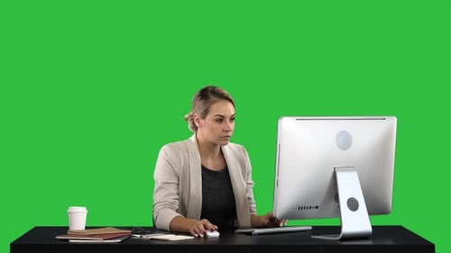 Beautiful Blonde Woman Working on Computer on A Green Screen