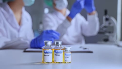 Coronavirus Vaccine Vials in Lab with Scientists