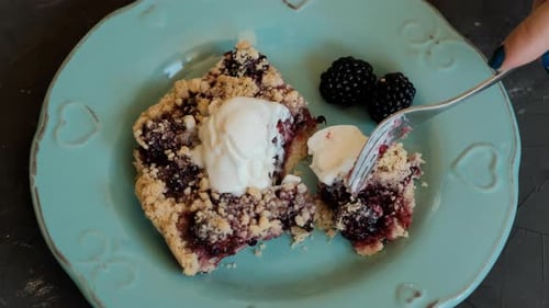 Piece of Blackberry Pie Topped with Ice Cream