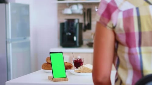Woman Looking at Smartphone with Green Screen
