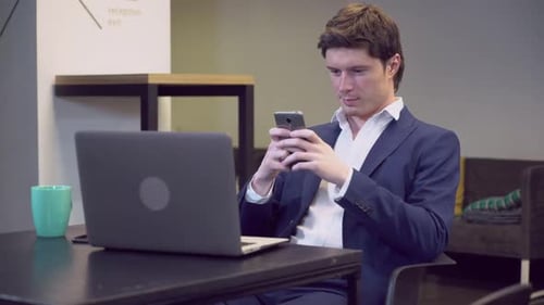 Man Using Smartphone in Modern Office Setting