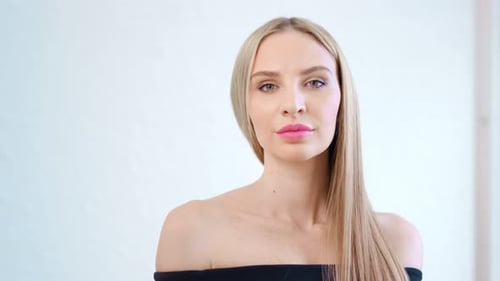 Medium Closeup Portrait of Fashionable Woman Posing at Studio White Background