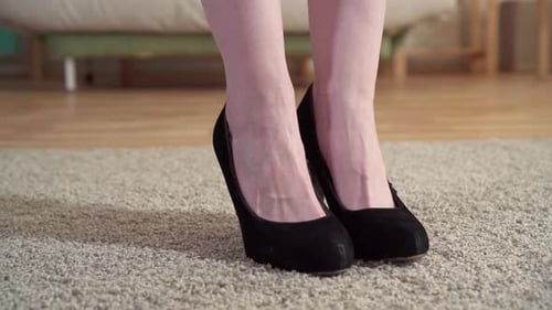 Close Up of a Woman in Heels Massaging Her Legs After Work