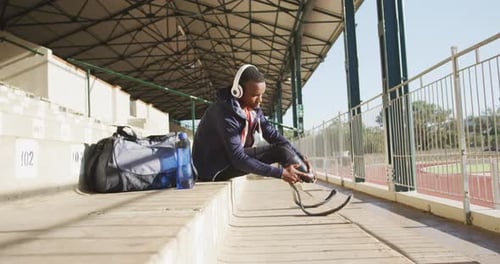 Athlete Attaching Prosthetic Leg in Sunny Stadium