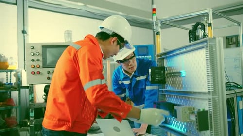 smart asian technical engineer working with assemble involved in the machine working design process