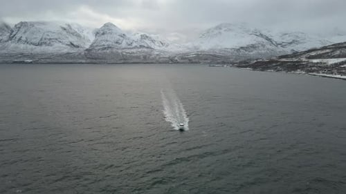 Boot beschleunigt in der Arktis entlang des Ozeans, eisige feindliche Bedingungen, Drohnenüberflug