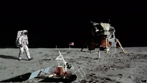 Astronaut Walks on Moon Surface with Lunar Module