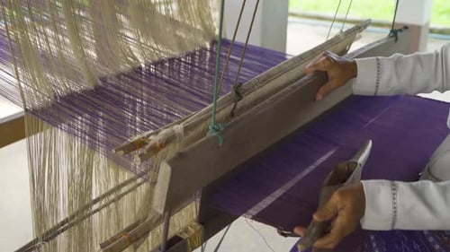 Local people hands using traditional manual weaving wool handloom