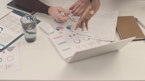 Multiethnic Businessmen Discussing Finances in Office