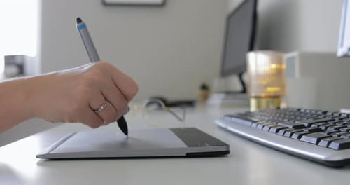 Woman's Hand Using Graphics Tablet and Stylus