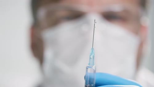 Syringe Needle Close-up in Hospital with Medical Professional