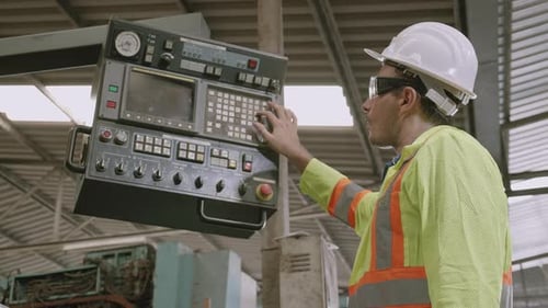 Maintenance engineer control automatic and pressing machine with panel in factory.