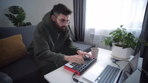 Young Adult Plays Electronic Keyboard at Home