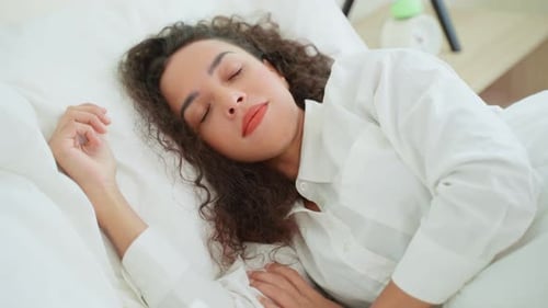 Woman Waking Up and Stretching in Bed