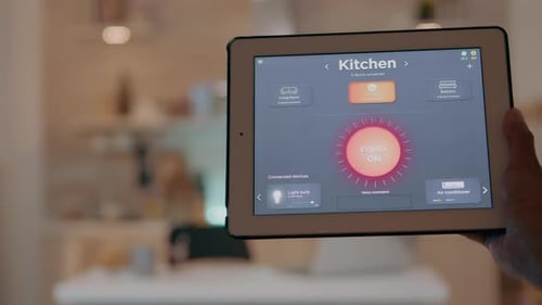 Man Uses Tablet to Control Smart Home Lighting