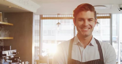 Smiling Young Adult Cafe Worker in Bright Coffee Shop