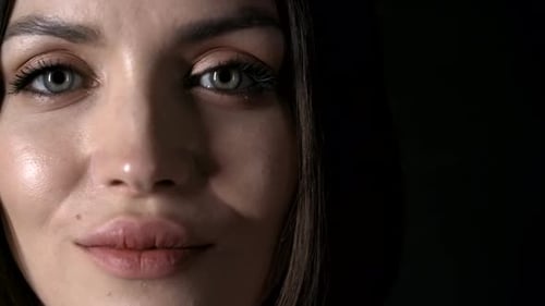 Close-Up of Woman's Face in Dark Studio