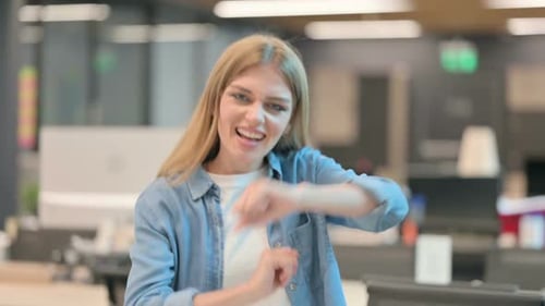 Young Woman Dancing Joyfully in the Office