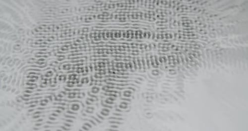 Petites formes cymatiques abstraites sur fond gris clair. Expériences cymatiques avec de l'eau. Fermeture statique