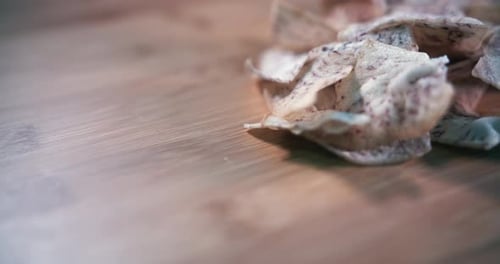 Close interior Shot of a Pile Taro Chips Spinning Into Focus