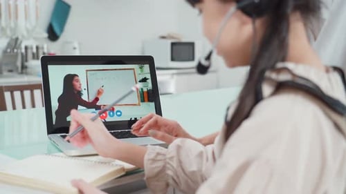 Homeschool Asian little young girl learning online class from school teacher by digital remote class