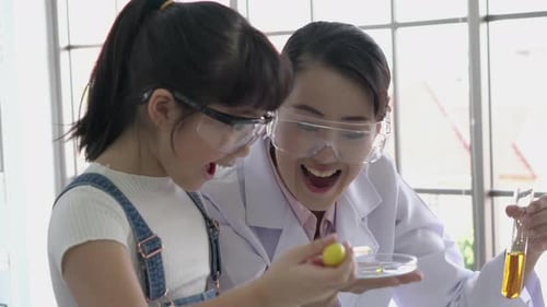 Girl and Woman Doing a Science Experiment