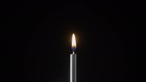 Candle Being Lit and Extinguished in Dark