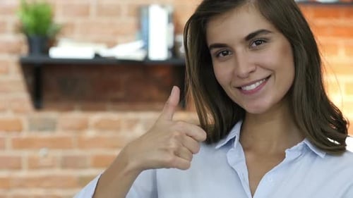 Woman Smiling and Giving Thumbs Up Close Up