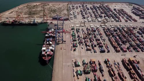 Industrial Cargo Area with Container Ship in Dock at Port, Aerial View