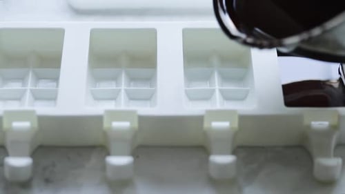 Chocolate Being Poured Into Mold for Dessert