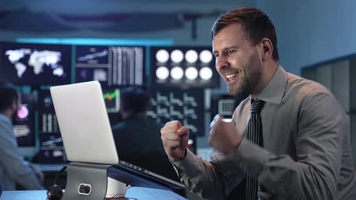 Excited Man Celebrates Business Success with Coworkers