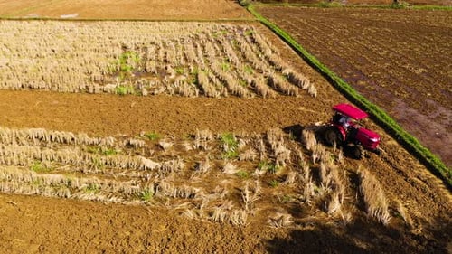 Aerial View of Tractor Tilling Rural Field