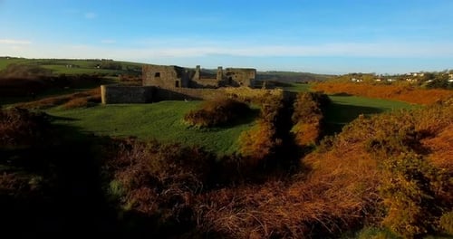 Woman Visiting Old Stone Castle Ruins in Countryside