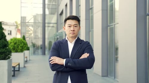 portrait young confident successful asian businessman looking at camera.