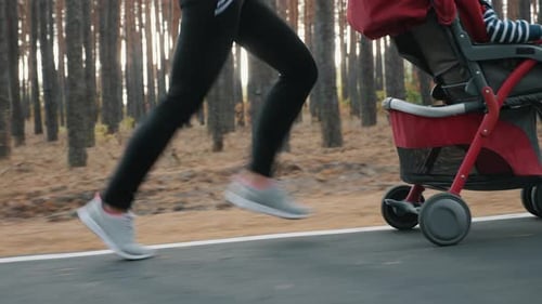 Woman Running with a Baby Stroller