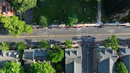 Top down aerial of people lining street, waiting for parade to start. Historic small town America ce