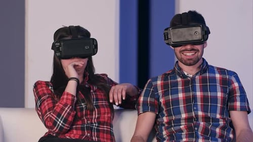 Young Adults Using VR Headsets on Couch