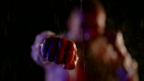 Man Boxing in the Rain at Night