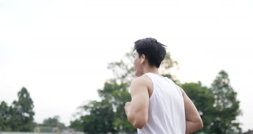 Young Man Jogging Outdoors for Fitness