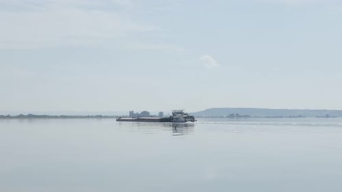 River Danube border of Serbia and Romania and cargo ship 4K 2160p 30fps UltraHD tilting footage - Ba