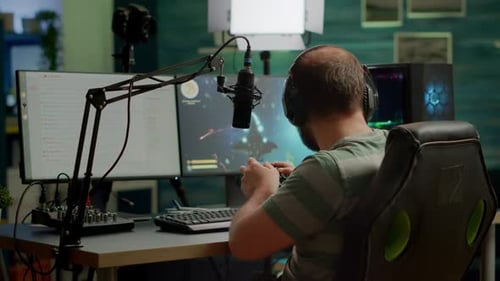 Gamer with Headphones Plays Computer Video Game