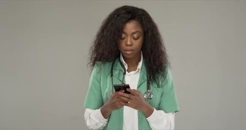 Black Medical Practitioner Using Smartphone
