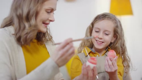 Happy Woman and Girls Decorating Easter Eggs
