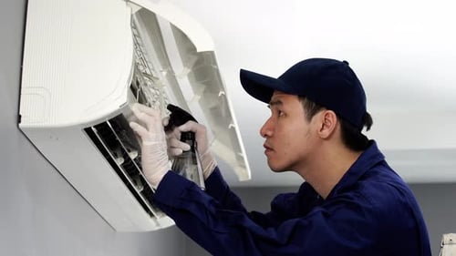 technician service cleaning the air conditioner indoors