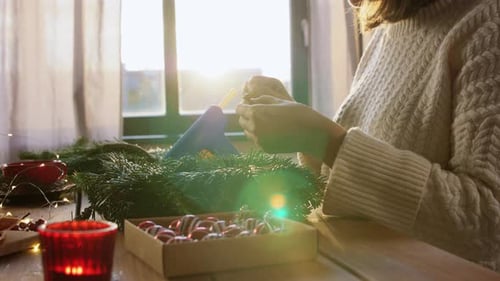 Woman Crafting a Holiday Wreath at Home