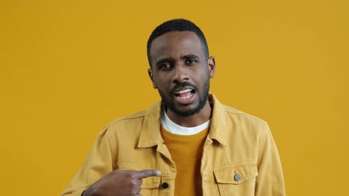Portrait of AfroAmerican Guy Pointing at Himself Then Crossing Arms Showing No Gesture Shaking Head